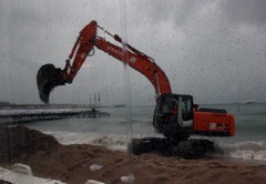 The digger arrives to put the beach back on the beach