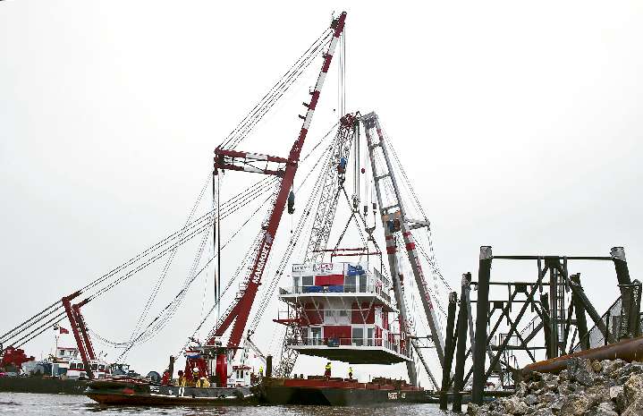 Refurbished Top Houses being craned onto base
